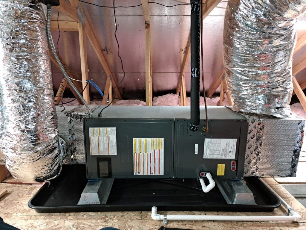 HVAC system installed in attic with ductwork and insulation visible. Energy-efficient setup.