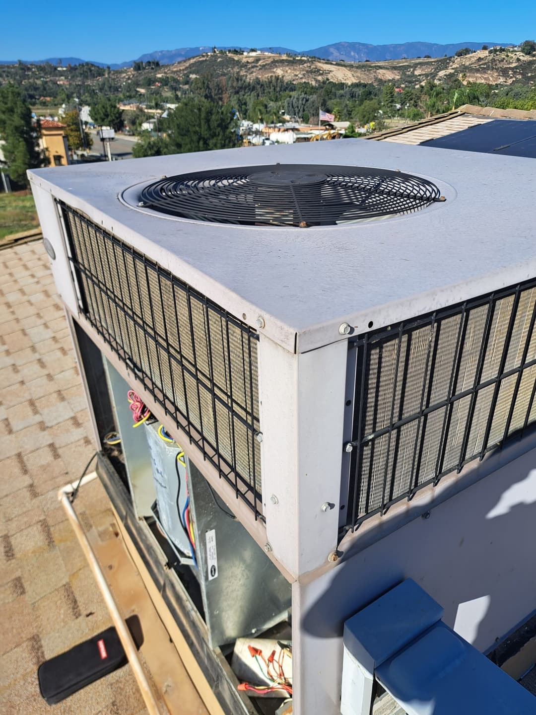 Rooftop air conditioning unit with mountain view in the background.